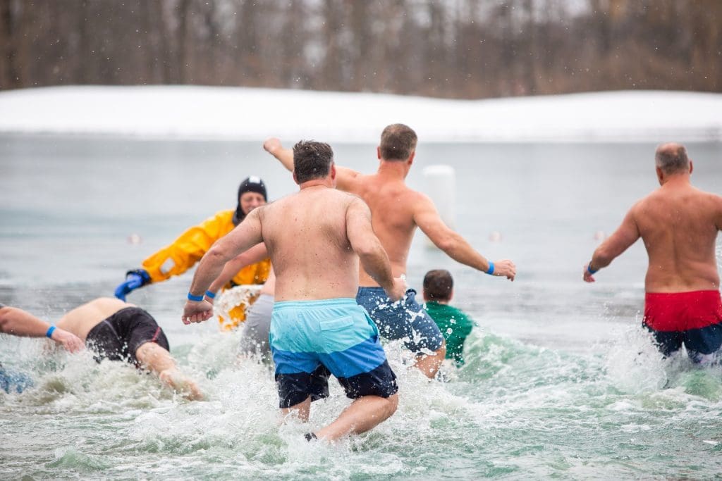 Members of school community participating in polar plunge fundraiser