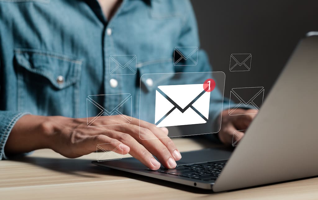 PTA volunteer on laptop reviewing email inbox