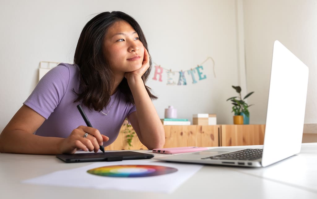 Female Student Sitting at Desk Working on Graphic Design
