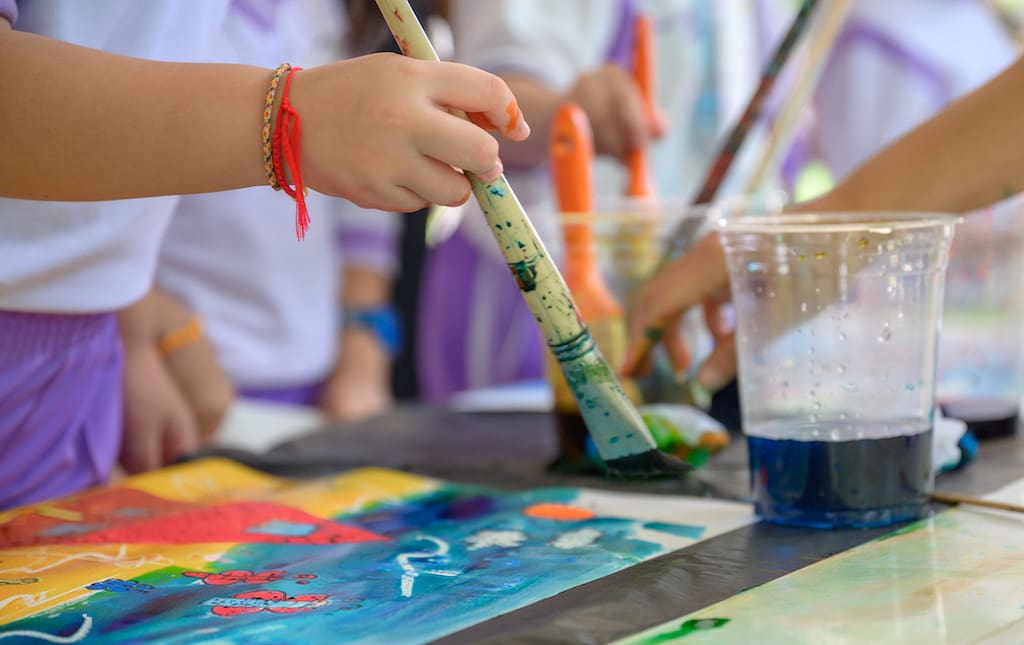 Young Children Painting With Colorful Paints