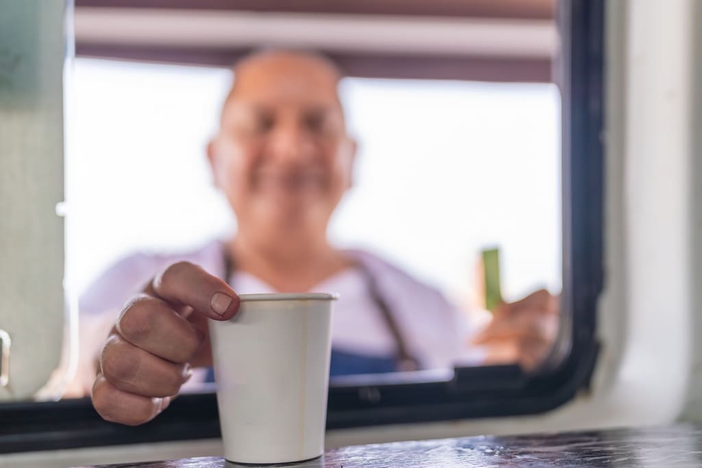 School bus driver enjoying hot coffee from drink station