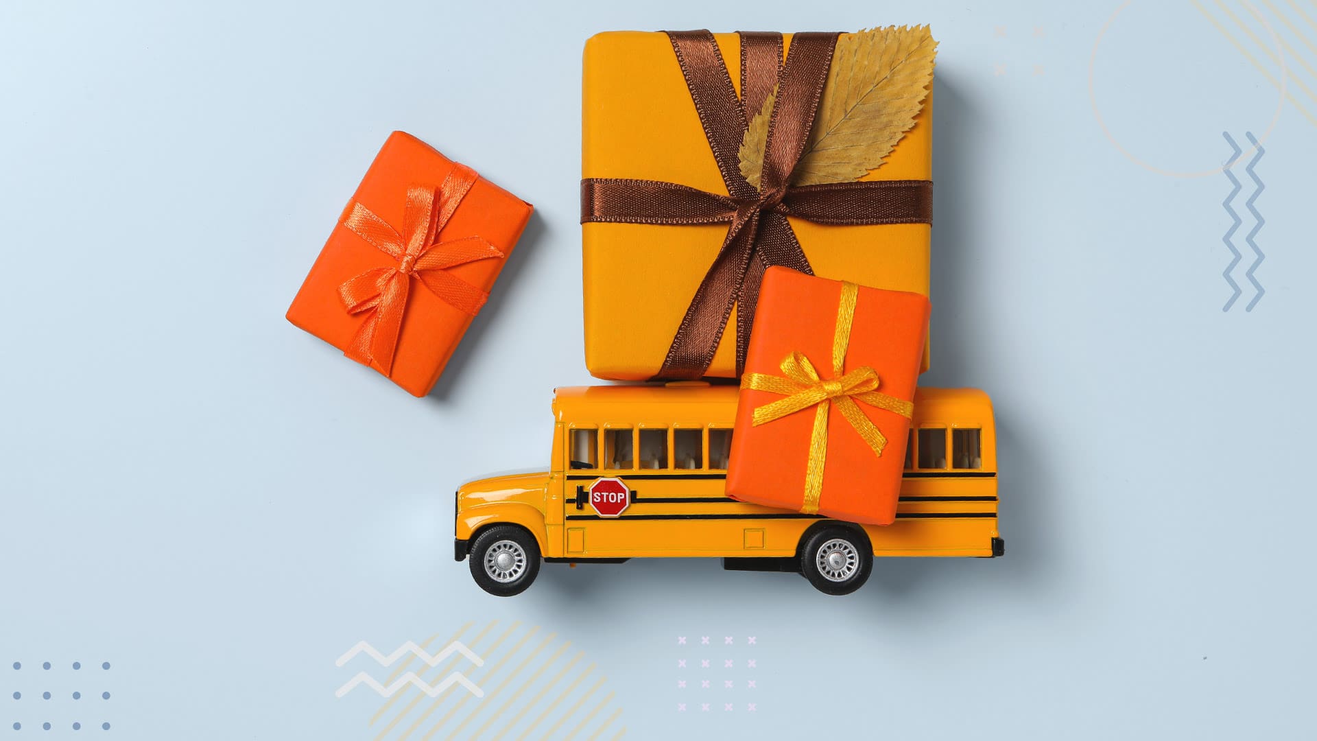 Yellow school bus figure with present laid out on a table