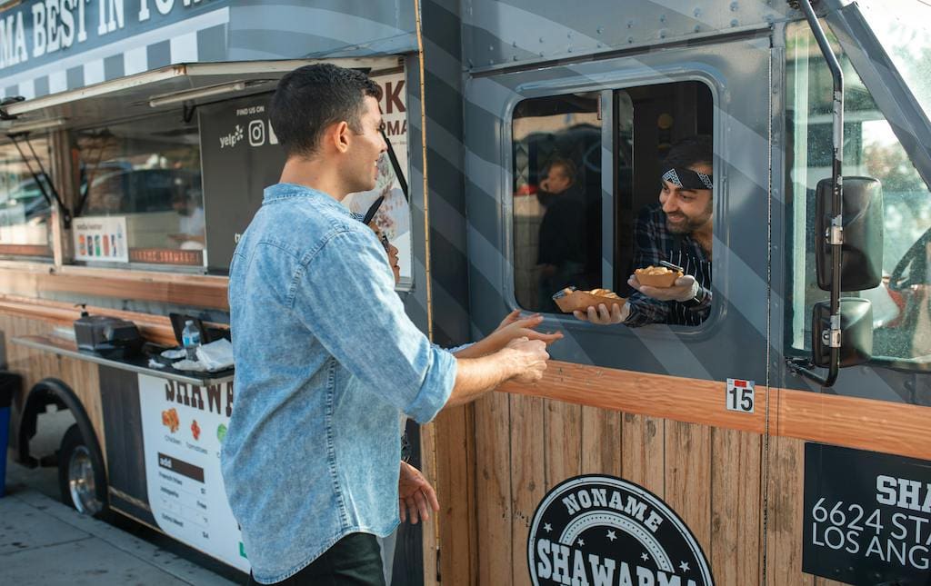man receiving food from food truck