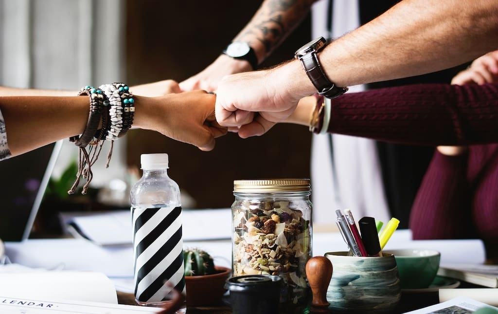 group of people fist bumping