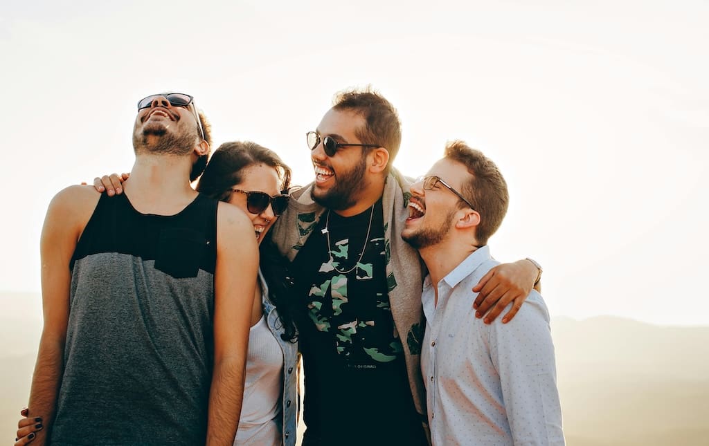 group of people embracing and laughing
